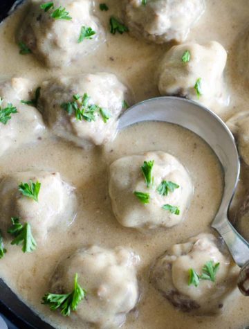 swedish meatballs in skillet with spoon